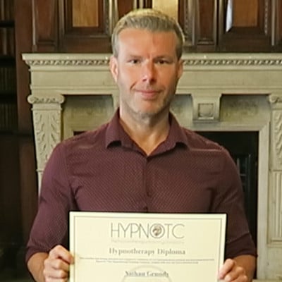 Hypnotherapy graduate, holding the hypnotherapy diploma certificate.